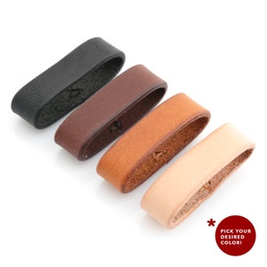 May include: Four leather straps in black, brown, tan, and natural colours. The straps are rectangular and have rounded edges.  Pick your desired colour!