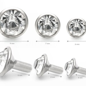 May include: Three sizes of clear crystal round and prong-set gem stones with a silver setting. The gems are 9 mm, 7 mm, and 6 mm in diameter. Three silver prong-set gem stones with a silver post are 4 mm in length.