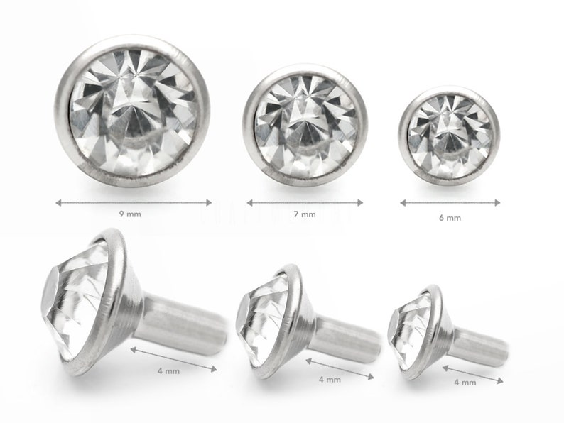 May include: Three sizes of clear crystal round and prong-set gem stones with a silver setting. The gems are 9 mm, 7 mm, and 6 mm in diameter. Three silver prong-set gem stones with a silver post are 4 mm in length.