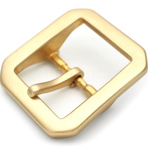 May include: A gold-toned metal buckle with a square frame and a single prong.