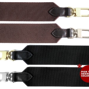 May include: Two fabric straps with leather accents and metal clasps. The straps are brown and black. The text "PICK YOUR DESIRED COLOR!" is on a red circle.