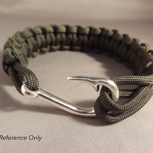 May include: A green paracord bracelet with a silver hook clasp.