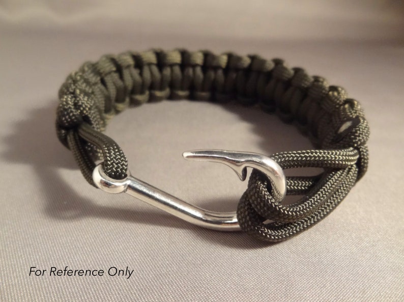 May include: A green paracord bracelet with a silver hook clasp.
