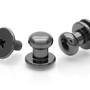 May include: Three black metal screw-on push buttons with a rounded top and a flat base. The buttons have a black finish.