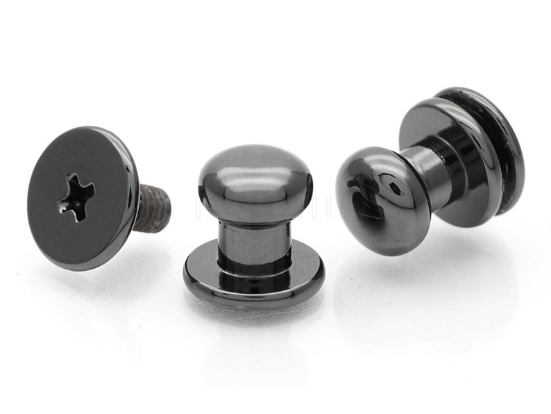 May include: Three black metal screw-on push buttons with a rounded top and a flat base. The buttons have a black finish.