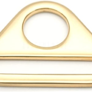 May include: Gold-toned metal triangle-shaped buckle with a round hole and a rectangular opening.