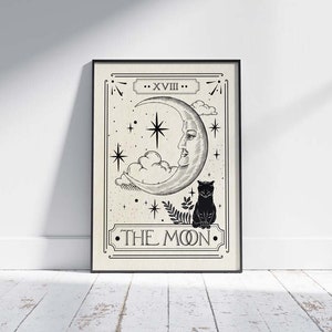 May include: A black and white tarot card illustration of The Moon card. The card features a crescent moon with a face, a cat, and stars. The text "XVIII. THE MOON." is printed on the card.
