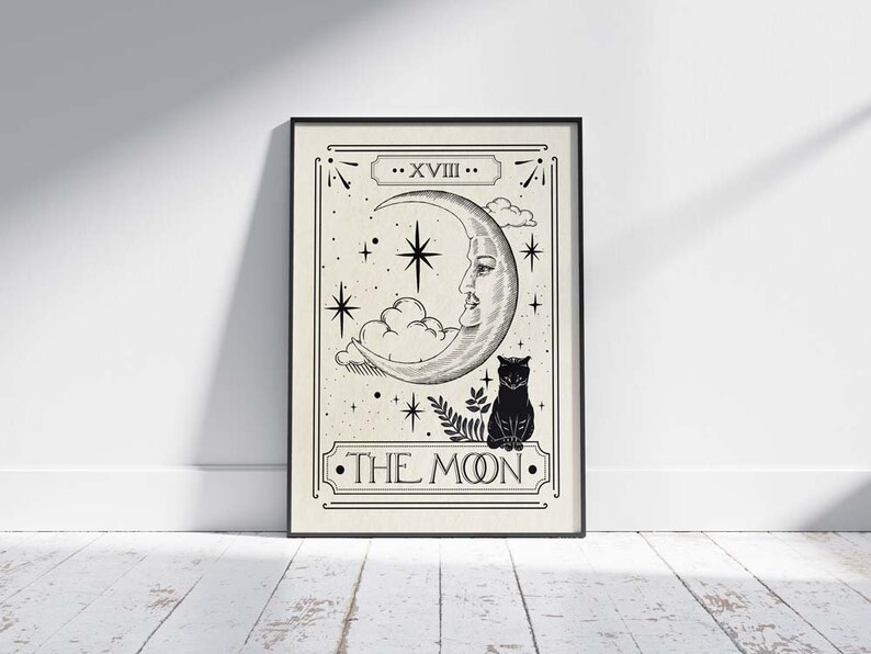 May include: A black and white tarot card illustration of The Moon card. The card features a crescent moon with a face, a cat, and stars. The text "XVIII. THE MOON." is printed on the card.
