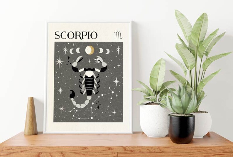 May include: A black and white illustration of a scorpion with a gold crescent moon and stars on a gray background. The text "SCORPIO" and the astrological symbol for Scorpio are at the top of the image.