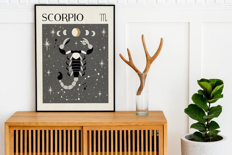 May include: A black framed poster with a gray background featuring a black and white scorpion illustration with the text "SCORPIO" and the astrological symbol for Scorpio.