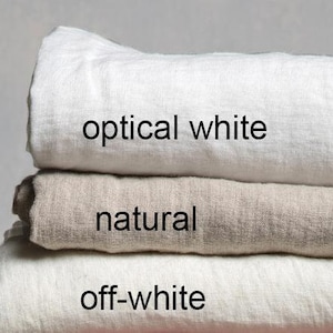 May include: Three linen fabric swatches stacked on top of each other. The top swatch is optical white, the middle swatch is natural, and the bottom swatch is off-white.