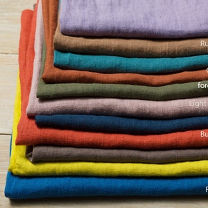 May include: A stack of 11 fabric swatches in various colors, including lavender, rusty brown, teal, cinnamon, forest green, light purple grey, navy blue, burn orange, cocoa, citron, and royal blue.
