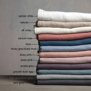 May include: Stack of 12 linen fabric swatches in various colors, including optical white, natural, off white, canyon rose, blue, dusty blue, dusty pink, purple grey, greyish duck egg, light grey, and dark grey.