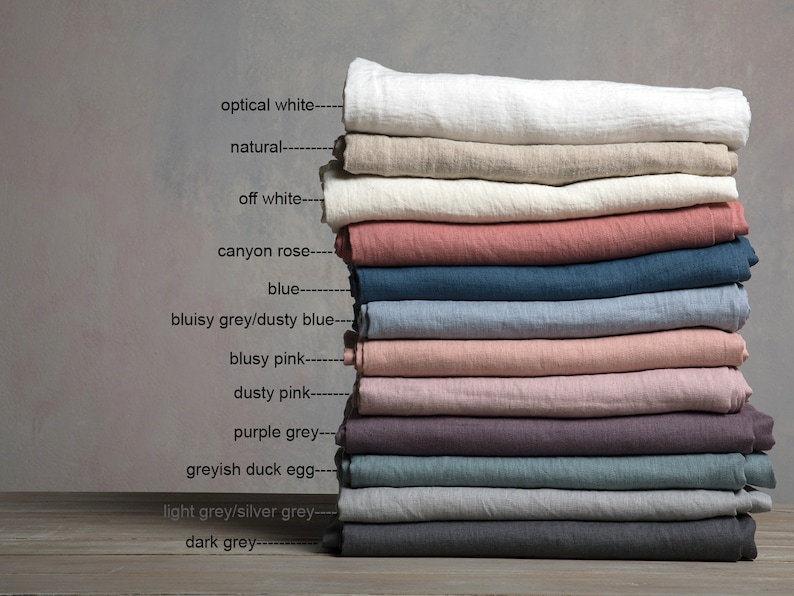 May include: Stack of 12 linen fabric swatches in various colors, including optical white, natural, off white, canyon rose, blue, dusty blue, dusty pink, purple grey, greyish duck egg, light grey, and dark grey.