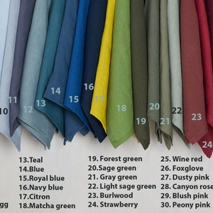 May include: A swatch card with 33 different colors of fabric. The colors are arranged in a row from left to right. The colors are peach, burnt orange, cinnamon, rusty brown, saffron, cocoa, dark grey, light grey, icy blue, bluish grey, blueberry, grayish duck egg, teal, blue, royal blue, navy blue, citron, matcha green, forest green, sage green, gray green, light sage green, burlwood, strawberry, wine red, foxglove, dusty pink, canyon rose, blush pink, peony pink, dusty purple grey, purple grey, and lavender.