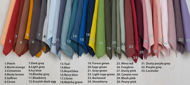 May include: A swatch card with 33 different colors of fabric. The colors are arranged in a row from left to right. The colors are peach, burnt orange, cinnamon, rusty brown, saffron, cocoa, dark grey, light grey, icy blue, bluish grey, blueberry, grayish duck egg, teal, blue, royal blue, navy blue, citron, matcha green, forest green, sage green, gray green, light sage green, burlwood, strawberry, wine red, foxglove, dusty pink, canyon rose, blush pink, peony pink, dusty purple grey, purple grey, and lavender.