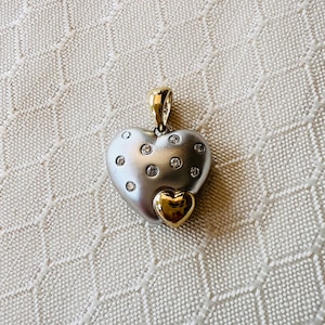 14K Two Tone Gold Cute heart pendant with round diamonds .12 cts with a gold heart on the side measuring .75 inches long