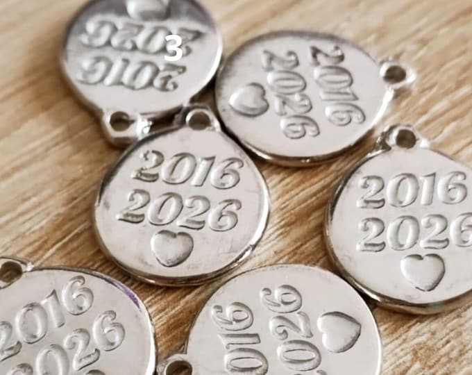 Round medal in raw tinplate 2016/2026 - ø18mm