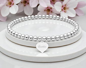 Pulsera personalizada de plata con forma de corazón: regalo para tía, diseño con cuentas elásticas.