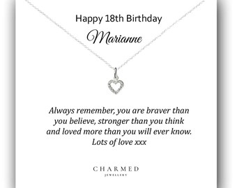 May include: A silver necklace with a heart-shaped pendant, displayed on a white card. The card reads "Happy 18th Birthday Marianne" and includes a loving message. The brand name "CHARMED JEWELLERY" is at the bottom.