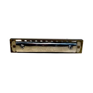 May include: A rectangular harmonica with a polished silver-tone metal cover plate featuring the engraved text World Star Special Harmonica. The instrument has a dark brown body with visible air channels and two small circular decorative accents.