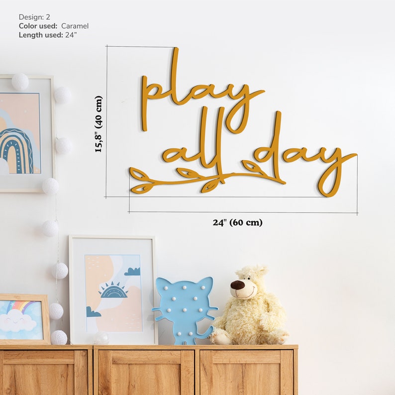 May include: A wooden sign with the text "play all day" in a caramel color. The sign is 24 inches long and 15.75 inches tall.