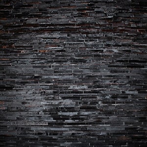 Top view of a Black Stripes Patchwork Cowhide Rug by Shine Rugs. A cowhide rug suitable for any kind of home decor. Bright and shiny natural black hair. Custom sizes, free shipping to US and Canada.