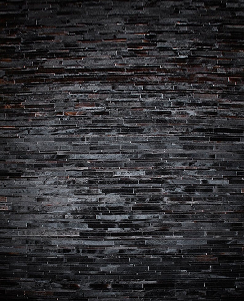 Top view of a Black Stripes Patchwork Cowhide Rug by Shine Rugs. A cowhide rug suitable for any kind of home decor. Bright and shiny natural black hair. Custom sizes, free shipping to US and Canada.