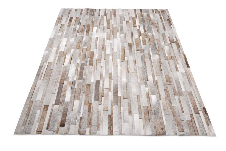 Taupe, Beige, Gray Stripes Patchwork Cowhide Rug. A classic and timeless exclusive design by Shine Rugs. The soft taupe and grays give this cowhide rug a warm tone, suitable for any style of home decor.