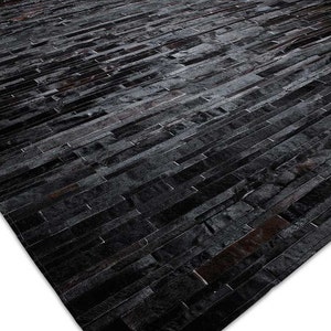 Black Stripes Patchwork Cowhide Rug by Shine Rugs. A cowhide rug suitable for any kind of home decor. Bright and shiny natural black hair. Custom sizes, free shipping to US and Canada.