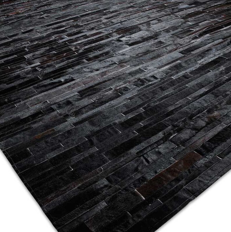 Black Stripes Patchwork Cowhide Rug by Shine Rugs. A cowhide rug suitable for any kind of home decor. Bright and shiny natural black hair. Custom sizes, free shipping to US and Canada.