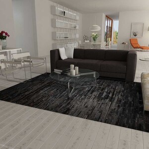 Open plan living room with Wassily Chairs and a Black Stripes Patchwork Cowhide Rug by Shine Rugs. A cowhide rug suitable for any kind of home decor. Bright and shiny natural black hair. Custom sizes, free shipping to US and Canada.