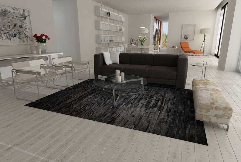 Open plan living room with Wassily Chairs and a Black Stripes Patchwork Cowhide Rug by Shine Rugs. A cowhide rug suitable for any kind of home decor. Bright and shiny natural black hair. Custom sizes, free shipping to US and Canada.
