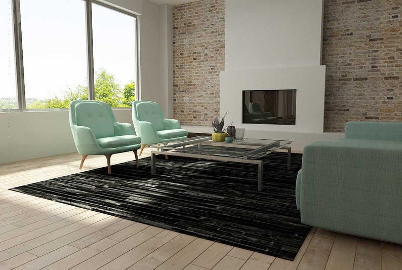 Sunny living room with a Black Stripes Patchwork Cowhide Rug by Shine Rugs. A cowhide rug suitable for any kind of home decor. Bright and shiny natural black hair. Custom sizes, free shipping to US and Canada.