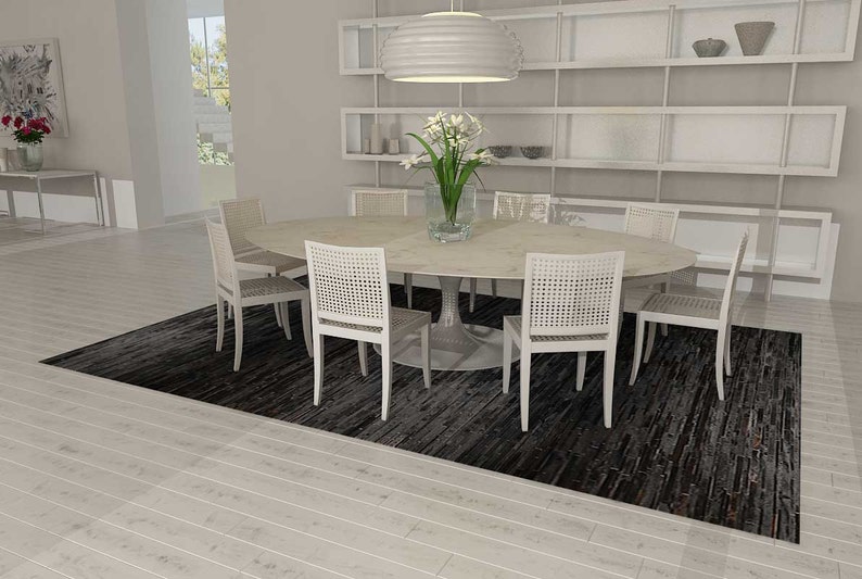 Open plan dining room with a Black Stripes Patchwork Cowhide Rug by Shine Rugs. A cowhide rug suitable for any kind of home decor. Bright and shiny natural black hair. Custom sizes, free shipping to US and Canada.