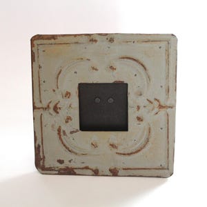 May include: A set of three ceramic mugs with a speckled, matte finish. The mugs are in shades of cream, light gray, and dark gray. Each mug has a simple, minimalist design and a rounded handle.