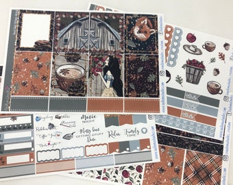 May include: A set of planner stickers with a fall theme. The stickers feature a variety of designs, including a barn, a fox, a cup of coffee, a basket of apples, and a girl with a crown of leaves. The stickers are printed on clear vinyl and have a matte finish.