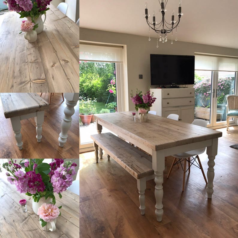 May include: A rustic farmhouse style dining table and bench set with a white painted finish. The table has a long, rectangular top made of reclaimed wood and turned legs. The bench is also made of reclaimed wood and has a simple design with turned legs.