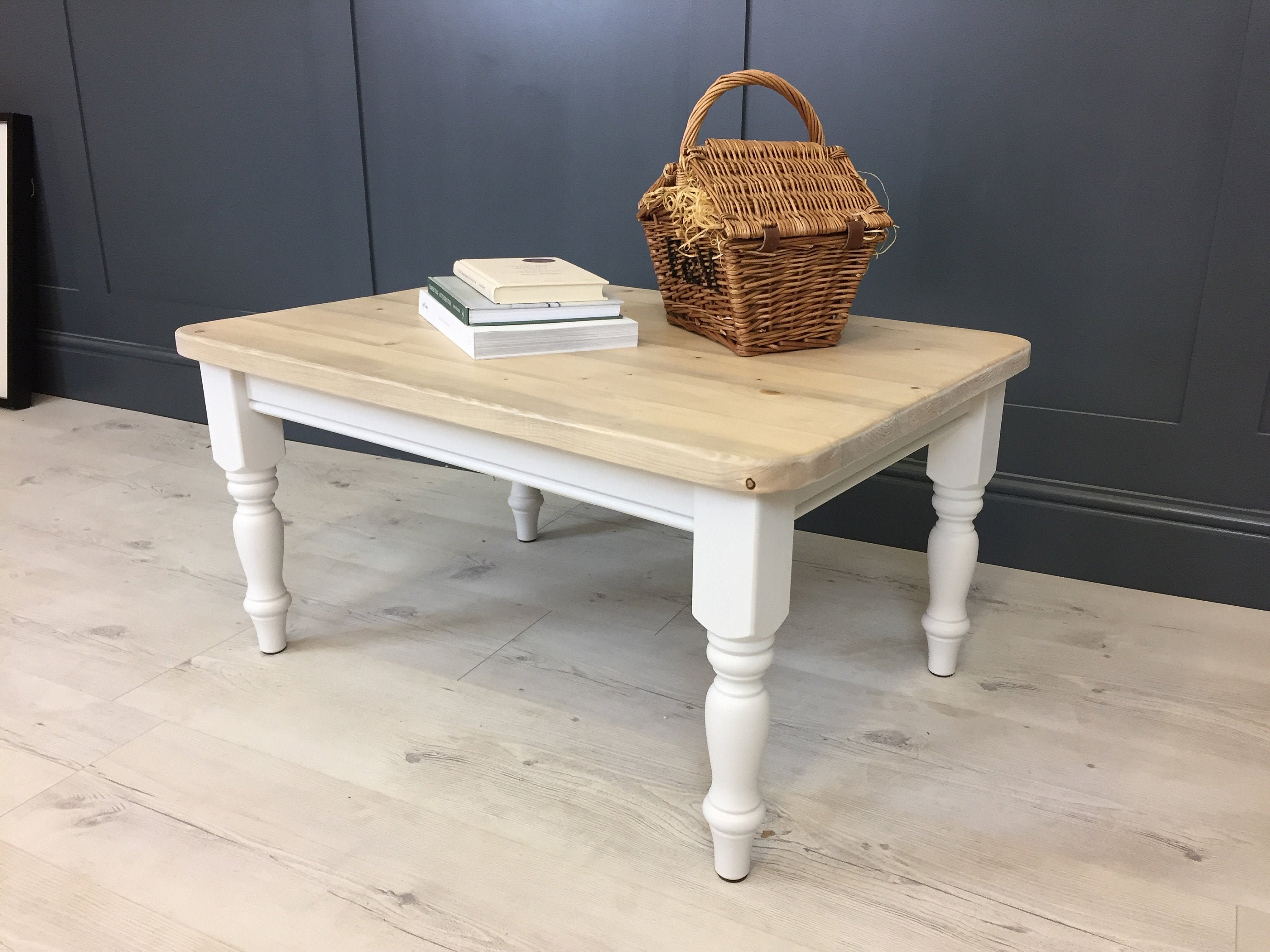 Country style rustic wood coffee table with painted turned legs in a farmhouse style