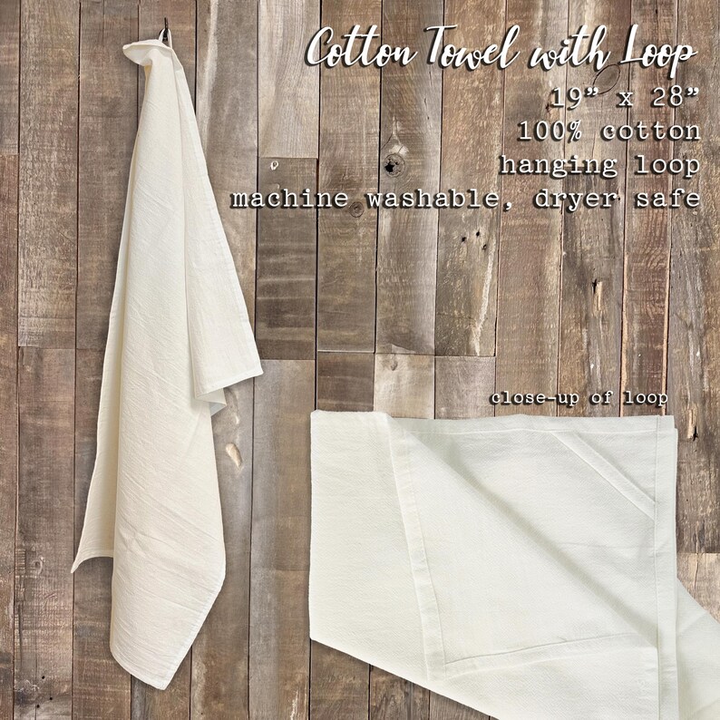 a white cotton towel hanging on a wooden wall.
