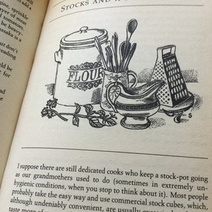 May include: A black and white illustration of kitchen utensils, a flour canister, and a grater. The illustration is from a vintage cookbook and includes the text "STOCKS AND A FEW SAUCES" and "FLOUR".