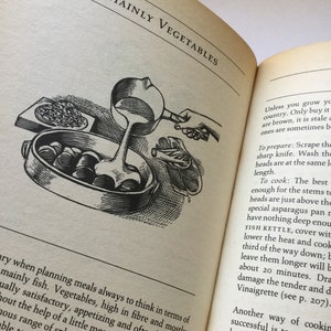 May include: A vintage cookbook open to a page titled "Mainly Vegetables". The page features a black and white illustration of a person cooking vegetables in a pot on a stovetop.