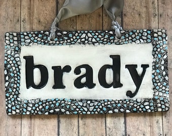 Baby Name Nursery Decor Name Sign in Black with white, tan and aqua Boarder Mosaic Highlights.  Perfect baby shower gift for new parents.