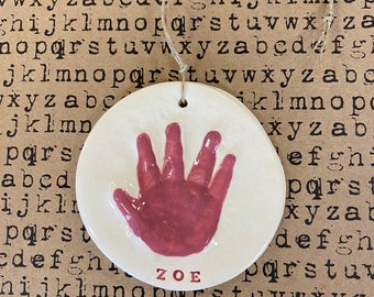 Newborn handprint ornament keepsake in pink ceramic