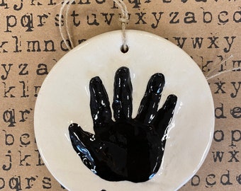 Newborn handprint ornament keepsake in black ceramic