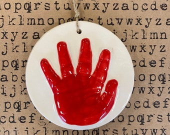 Newborn handprint ornament keepsake in red ceramic