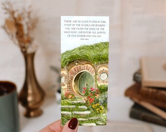 May include: A watercolor illustration of a hobbit hole with a green door and a quote from J.R.R. Tolkien: "There are no safe paths in this part of the world. Remember you are over the edge of the wild now, and in for all sorts of fun wherever you go."