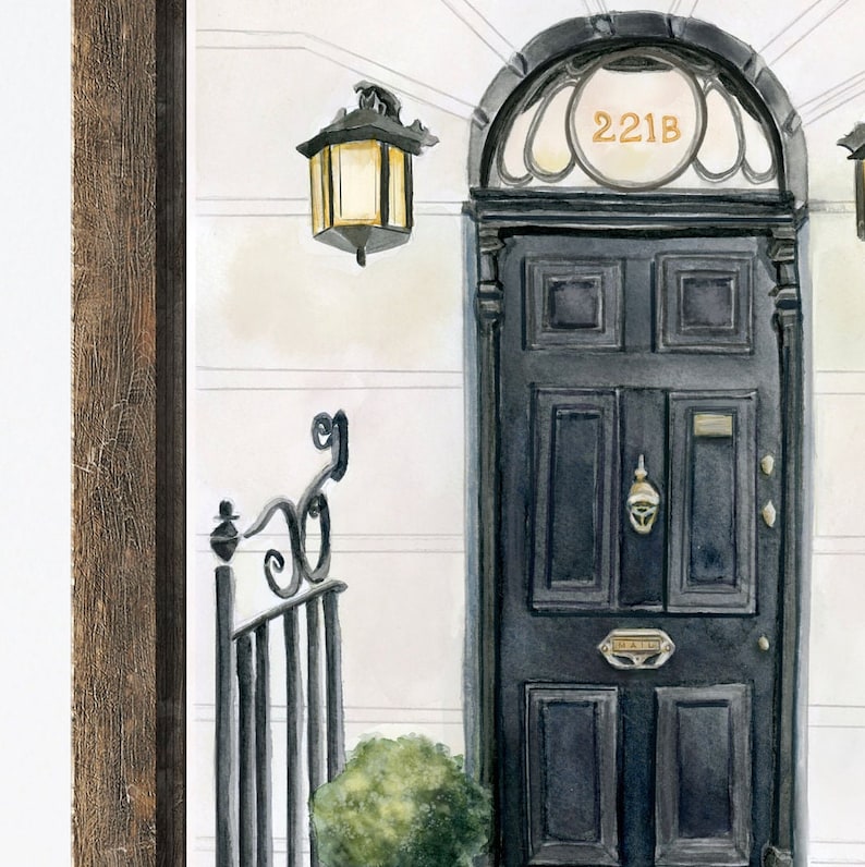 May include: A black door with a gold door knocker and a brass mailbox. The door has a rounded archway with the number "221B" above it. A black wrought iron gate with a decorative top is to the left of the door. A small green bush is in front of the door.
