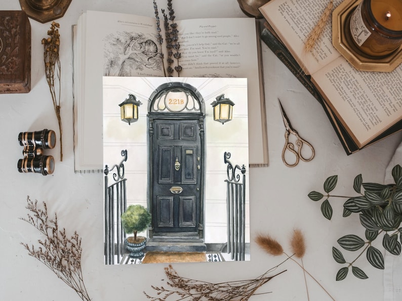 May include: A watercolor painting of a black door with a brass door knocker and the number "221B" above it. The door is flanked by two black wrought iron gates and two black lanterns.