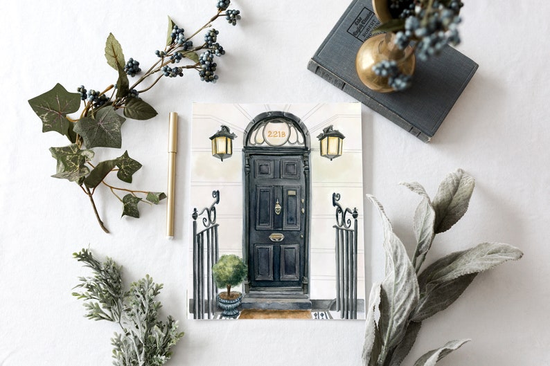 May include: A watercolor painting of a black door with a brass door knocker and the number 221B above it. The door is flanked by two black wrought iron gates and two black lanterns.
